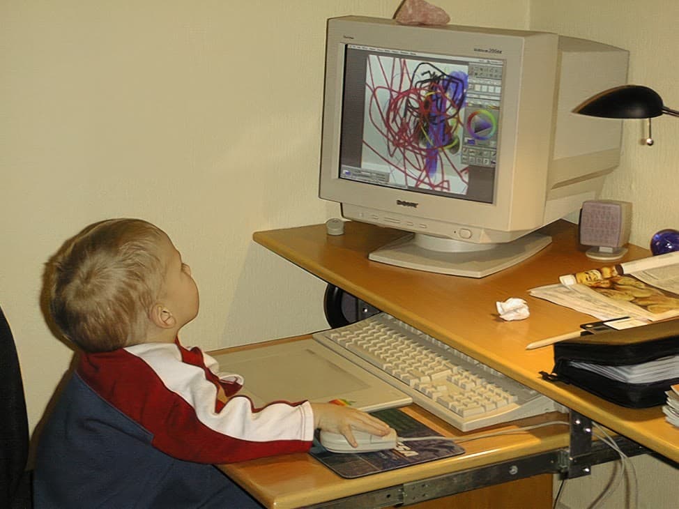 A four-year-old at a CRT computer, drawing in a paint program